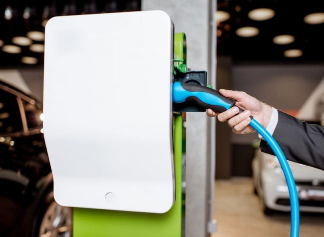 plugging-cable-into-the-charging-station-2022-01-18-23-45-02-utc